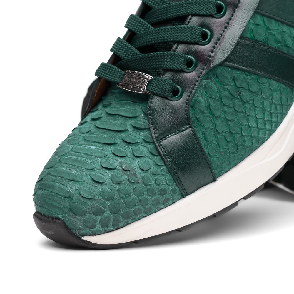 The Marco Di Milano Verona Green sneakers are luxury shoes with scale-like patterns, dark green accents, and white soles. One shoe is upright while the other lies on its side.