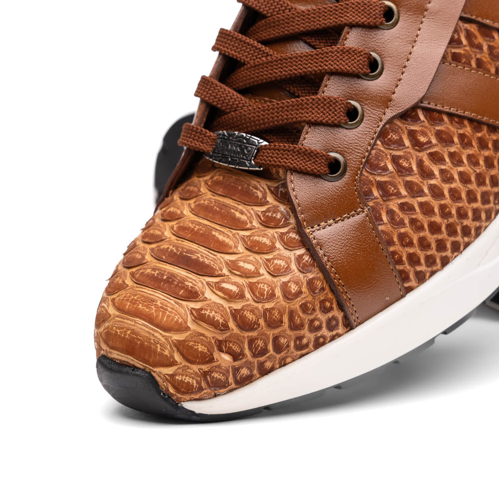 The Marco Di Milano Verona Honey is a brown luxury sneaker with a textured, reptile-like pattern, leather accents, brown laces, and a white sole. One men’s genuine calfskin shoe stands upright; the other displays its sole.