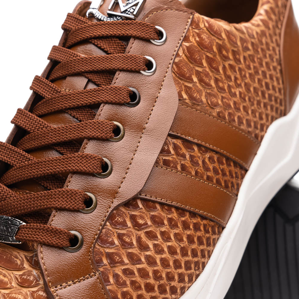 The Marco Di Milano Verona Honey is a brown luxury sneaker with a textured, reptile-like pattern, leather accents, brown laces, and a white sole. One men’s genuine calfskin shoe stands upright; the other displays its sole.