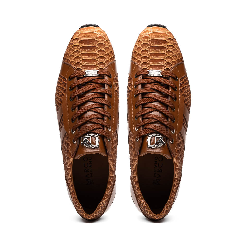The Marco Di Milano Verona Honey is a brown luxury sneaker with a textured, reptile-like pattern, leather accents, brown laces, and a white sole. One men’s genuine calfskin shoe stands upright; the other displays its sole.