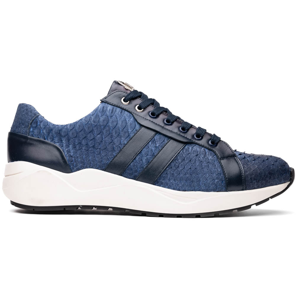 The Verona Navy sneakers by Marco Di Milano feature a blue python texture, navy laces, side stripes, and white rubber soles—luxury footwear with one shoe upright and the other on its side.