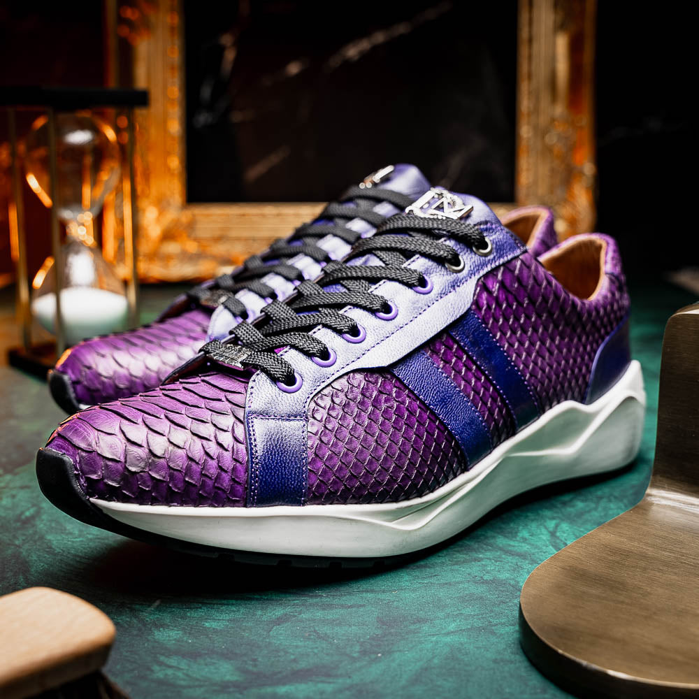 The Verona Purple by Marco Di Milano are hand-painted python sneakers with a textured scale pattern, black laces, and white soles—ideal for elevating any men's sneaker collection. One shoe stands while the other lies on its side.