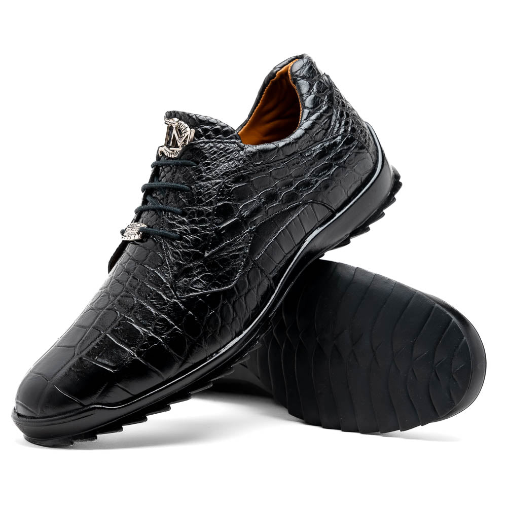 The Vulcan Black by Marco Di Milano are black, crocodile-patterned leather dress shoes with rubber soles—one upright and one displaying the sole. This luxury footwear features hand-painted finishes for a truly refined look.