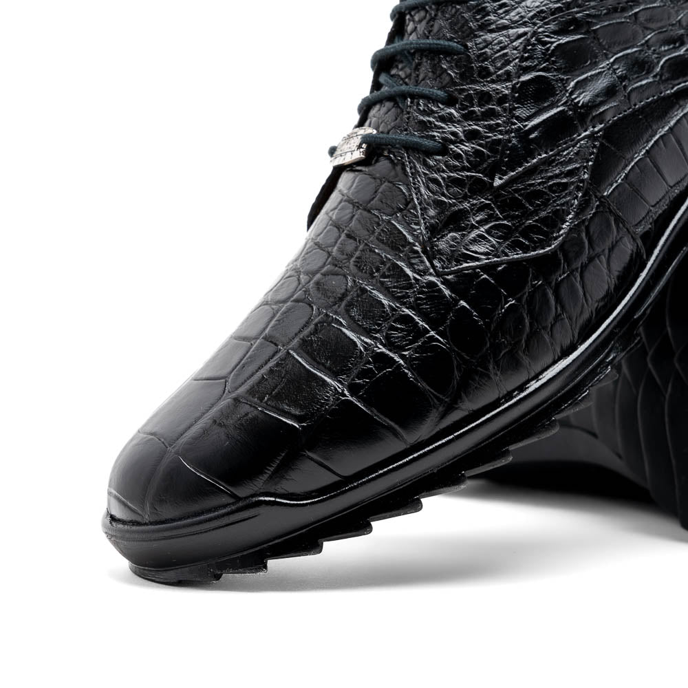 The Vulcan Black by Marco Di Milano are black, crocodile-patterned leather dress shoes with rubber soles—one upright and one displaying the sole. This luxury footwear features hand-painted finishes for a truly refined look.