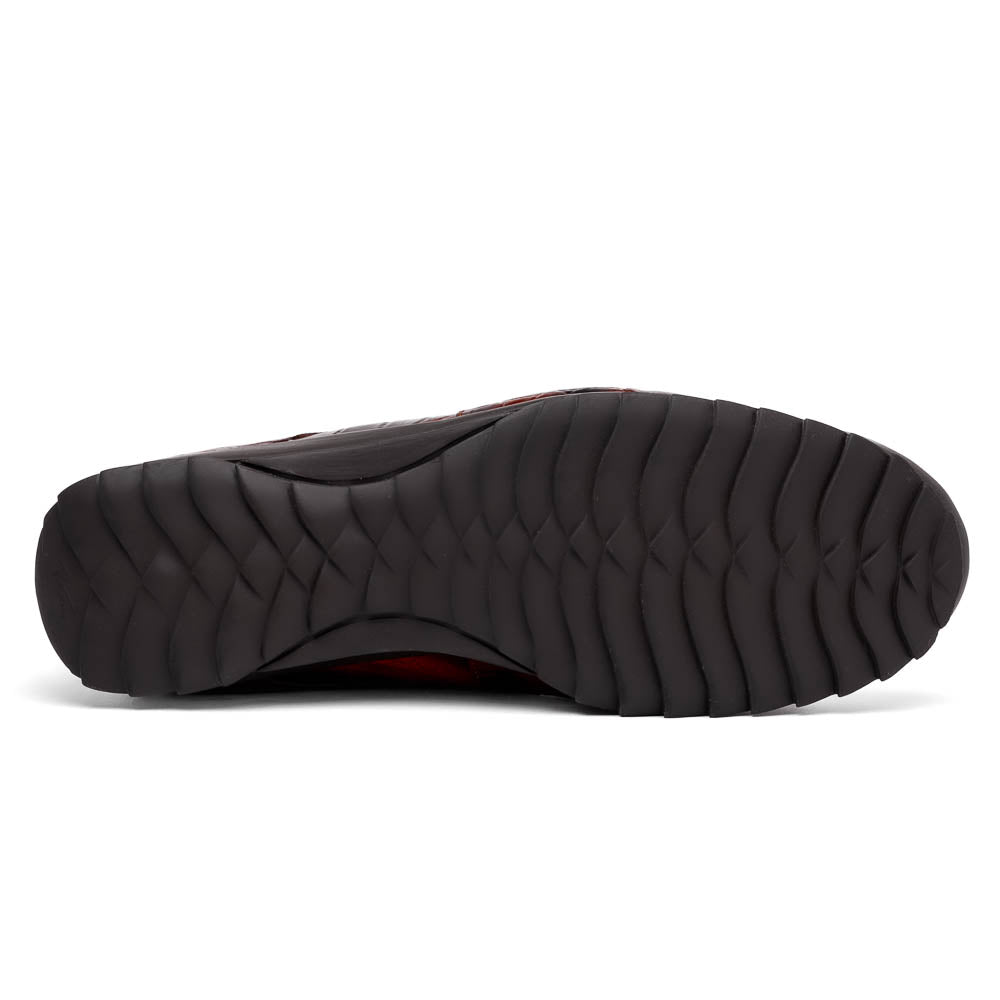 The Vulcan Rustic Cognac by Marco Di Milano features brown crocodile-pattern leather dress shoes with black rubber soles, one shoe upright and the other tilted—showcasing luxury footwear with exquisite hand-painted finishes.