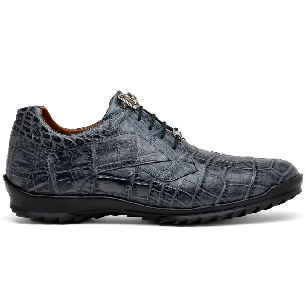 A pair of Marco Di Milano Vulcan Rustic Gray men's dress shoes, showcasing luxury footwear with crocodile-patterned leather, hand-painted finishes, and metal lace accents—one upright, one on its side to display the sole.