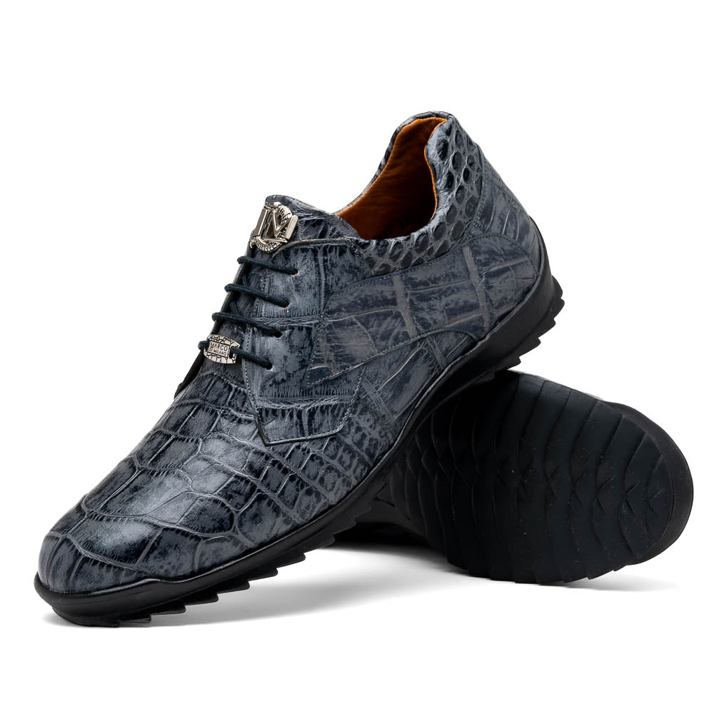 A pair of Marco Di Milano Vulcan Rustic Gray men's dress shoes, showcasing luxury footwear with crocodile-patterned leather, hand-painted finishes, and metal lace accents—one upright, one on its side to display the sole.