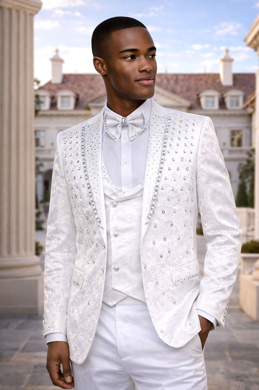 A man wearing the MANZINI PLATINUM 3-Piece Slim-Fit Men's Rhinestone Satin Floral Tuxedo Suit in White/White by Manzini stands outside a grand mansion.