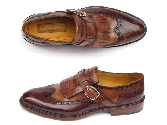 Introducing the Paul Parkman Wingtip Monkstraps Brown - 060-BRW, a pair of elegant brown leather shoes from the renowned brand Paul Parkman. These shoes showcase a stylish wingtip design with monk strap closures featuring buckle and fringe details. Hand-painted finishes and decorative perforations enhance their sophisticated look, while the durable Goodyear welted construction guarantees lasting comfort.