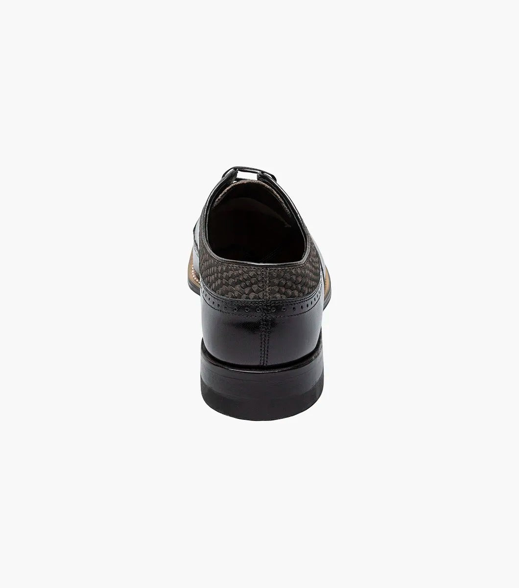 The Stacy Adams Dayton Python Print Wingtip Oxford in Black/Gray (00626-975) features kidskin leather with textured dark grey panels, lace-up closure, cushioned footbed, and a low heel. Shown on a white background.