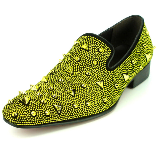 The FI-7364-R Black/Gold shoe by Fiesso offers a striking design, showcasing a yellow suede slip-on style accented with black trim, embellished with gleaming gold spikes and studs, and completed with a low heel.
