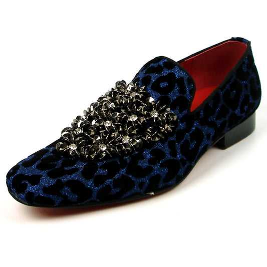 The FI-7421 Black Blue Slip on by Fiesso features a bold blue and black leopard print velvet upper with metallic stud clusters and a striking red interior, combining standout style and luxury craftsmanship.