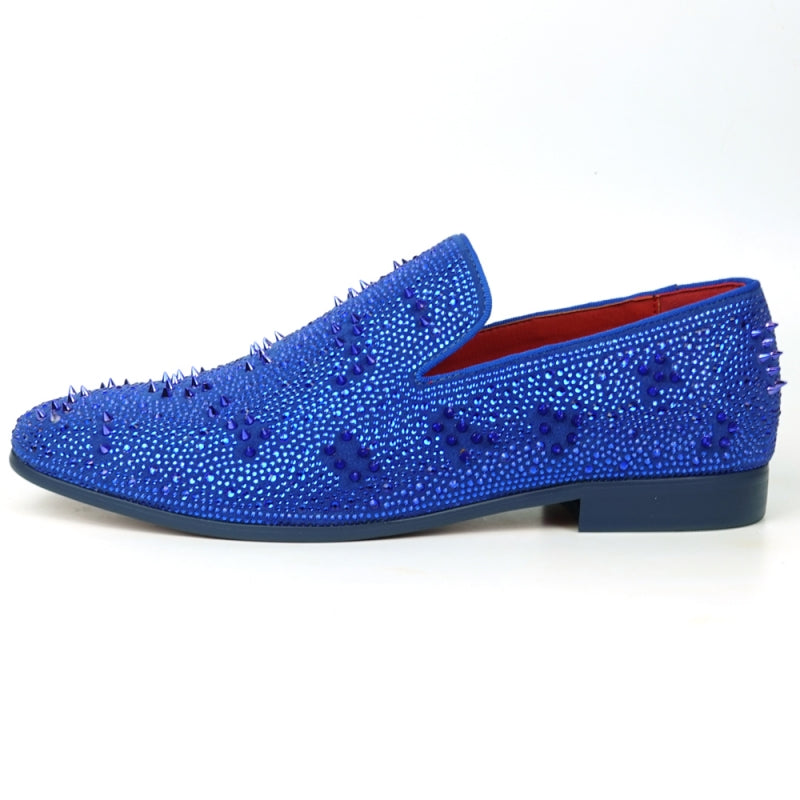 The FI-7516 Blue Suede Rhinestones Spikes Slip On Loafer from Fiesso by Aurelio Garcia effortlessly blends elegance with an edgy touch. Featuring blue rhinestone spikes and a bold red interior lining, this standout shoe is an ideal addition to any men's dress wardrobe, offering a unique flair that perfectly complements your style.