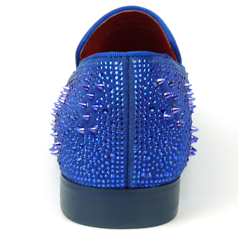 The FI-7516 Blue Suede Rhinestones Spikes Slip On Loafer from Fiesso by Aurelio Garcia effortlessly blends elegance with an edgy touch. Featuring blue rhinestone spikes and a bold red interior lining, this standout shoe is an ideal addition to any men's dress wardrobe, offering a unique flair that perfectly complements your style.