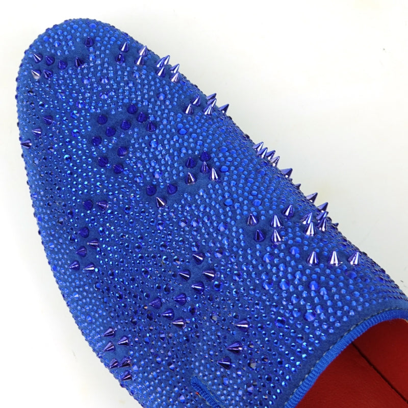 The FI-7516 Blue Suede Rhinestones Spikes Slip On Loafer from Fiesso by Aurelio Garcia effortlessly blends elegance with an edgy touch. Featuring blue rhinestone spikes and a bold red interior lining, this standout shoe is an ideal addition to any men's dress wardrobe, offering a unique flair that perfectly complements your style.