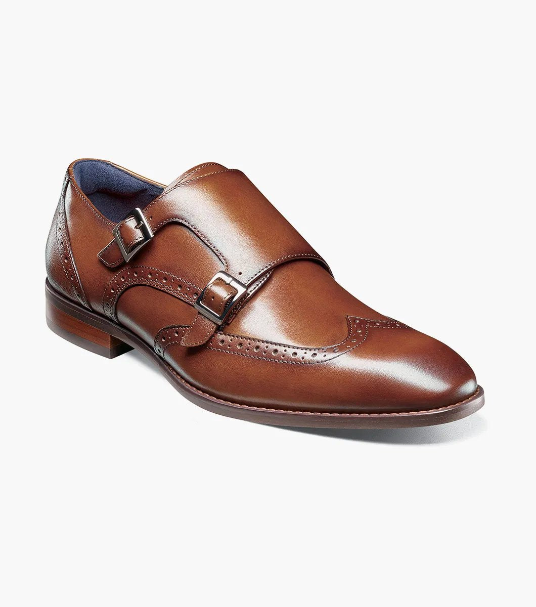 The STACY ADAMS Karson Wingtip Double Monk Strap dress shoe in Cognac features decorative perforations and a low heel, shown on a white background. Model: 25570-221.