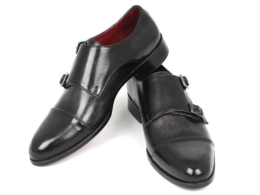 The Paul Parkman Captoe Double Monkstraps Gray & Black - 0457-GRY is gracefully showcased, featuring handcrafted double monk strap shoes with elegant silver buckles and luxurious calfskin leather, with one shoe slightly overlapping the other on a pristine white background.