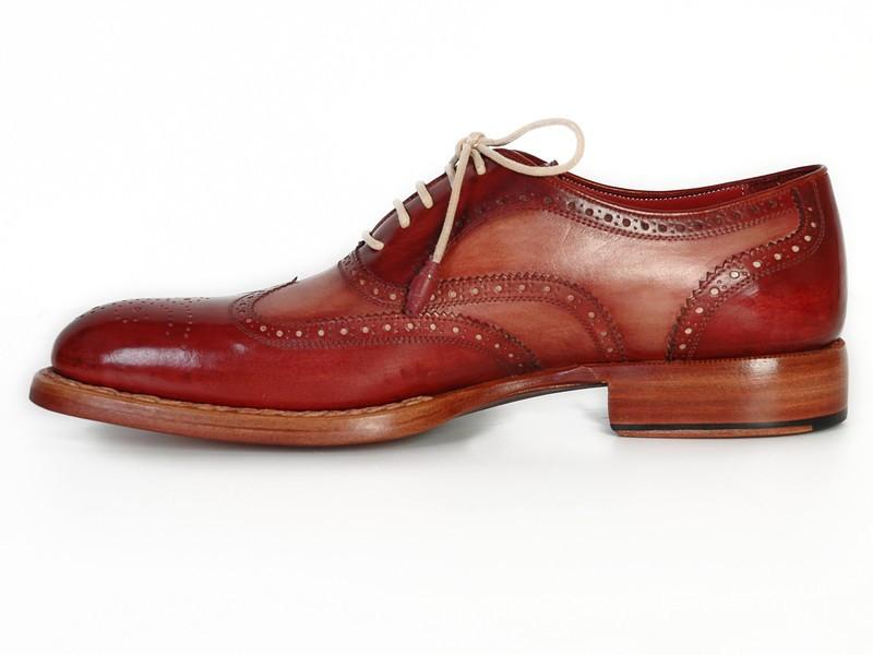 Discover the sophistication of the Paul Parkman Wingtip Oxfords in Bordeaux & Camel, featuring detailed perforations on exquisitely hand-painted leather. These brogue shoes, adorned with light brown laces and crafted with a Goodyear welt for lasting durability, are elegantly displayed from top and side views.