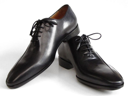 A pair of Paul Parkman Black Leather Oxfords Side Handsewn - 018-BLK, expertly crafted from exquisite Italian calfskin, with laces elegantly positioned against a white background.