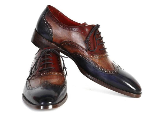 A pair of Paul Parkman Three Tone Wingtip Oxfords - PP2278, crafted by the renowned brand Paul Parkman, features polished leather with intricate brogue detailing and a captivating gradient of brown and blue hues. These hand-painted leather shoes exemplify expert craftsmanship and unique artistry.