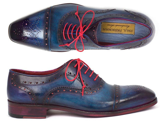 The Paul Parkman Captoe Oxfords Blue & Parliament - 024-PARL, by Paul Parkman, are men's Oxford-style shoes made from hand-painted blue leather. They feature red laces and intricate perforations, beautifully showcased from both side and top perspectives.