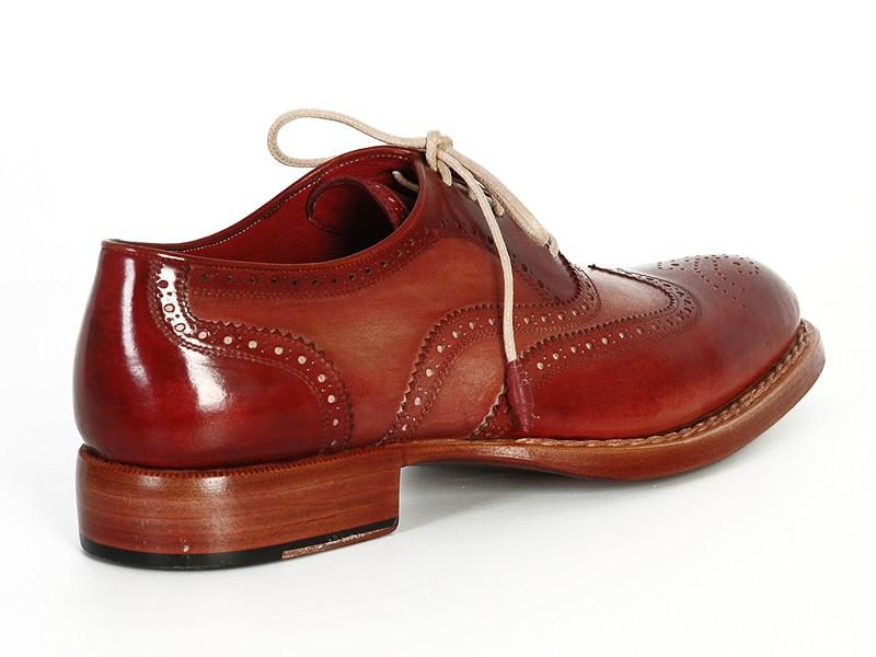 Discover the sophistication of the Paul Parkman Wingtip Oxfords in Bordeaux & Camel, featuring detailed perforations on exquisitely hand-painted leather. These brogue shoes, adorned with light brown laces and crafted with a Goodyear welt for lasting durability, are elegantly displayed from top and side views.