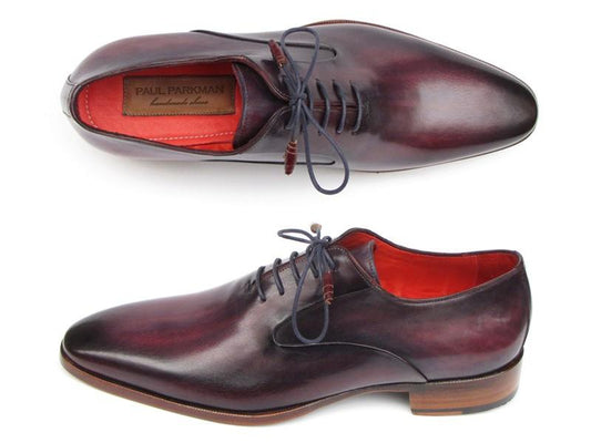 These Paul Parkman Plain Toe Oxfords in a purple hue are men's handmade shoes crafted from exquisite hand-painted leather. They feature blue laces, a red lining, and brown soles. The brand name is proudly displayed inside one of the shoes.
