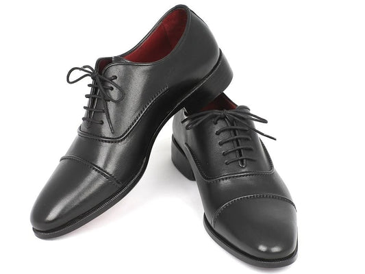 Introducing the Paul Parkman Captoe Oxfords Black - 077-BLK by Paul Parkman: a pair of black leather dress shoes in the classic Oxford captoe style. These men's handmade shoes feature a glossy finish and striking red interior lining, crafted with exquisite attention to detail. The hand-painted leather not only highlights elegance but also guarantees sophistication with every step.