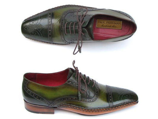 Two green side handsewn captoe Oxfords with brogue detailing, brown laces, and red interior lining are on display. The brand label inside reads "Paul Parkman." These Paul Parkman shoes showcase exquisite craftsmanship and offer a perfect fit.