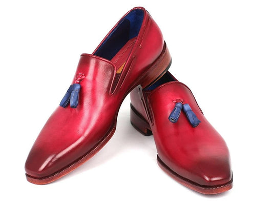 A pair of Paul Parkman Tassel Loafers in a stunning burgundy finish, highlighted with eye-catching blue tassels and complemented by an elegant wooden sole, are showcased beautifully on a pristine white background.