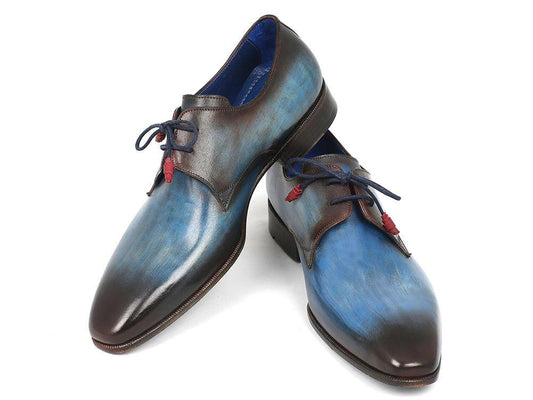 A pair of Paul Parkman Blue & Brown Hand-Painted Derby Shoes - 326-BLUBRW, featuring a polished leather exterior with an ombre blue and brown finish and accented by red laces in a classic Derby style.