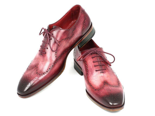 Introducing the Paul Parkman Wingtip Oxfords Burgundy Handpainted Calfskin - 741-BUR: a stunning pair of dress shoes featuring a red ombre leather design, burgundy hand-painted wingtip embellishments, and intricate brogue detailing. Crafted from supple calfskin upper and finished with classic laces, these shoes are a testament to Paul Parkman's exquisite craftsmanship.