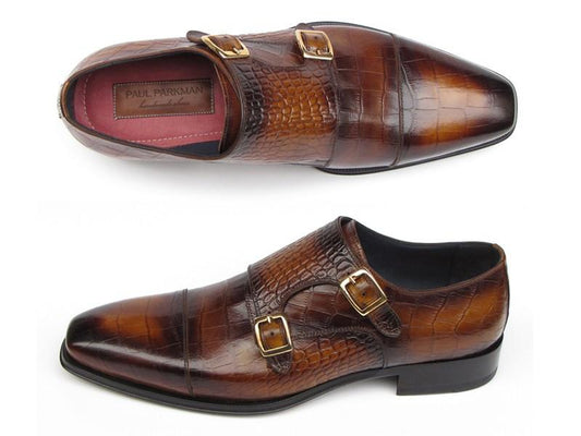 The Paul Parkman Brown Crocodile Embossed Calfskin Double Monkstrap - 045-APR-BRW by Paul Parkman showcases meticulous craftsmanship with its luxurious, alligator-textured leather and two refined brass buckles.