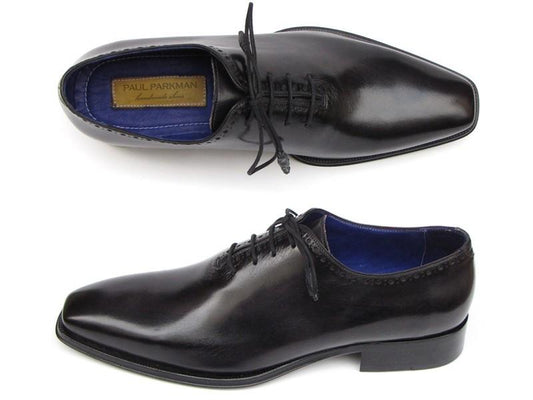 Two pairs of Paul Parkman Plain Toe Oxfords Wholecut Black - 025-BLK are displayed, featuring a luxurious black leather exterior complemented by blue lining and laces. One shoe is presented in a top-down view while the other is shown from the side, highlighting the sophisticated craftsmanship of these handmade men's shoes by Paul Parkman.