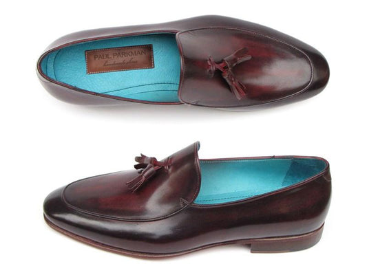 The "Paul Parkman" Tassel Loafer Black & Purple Shoes - 049-BLK-PURP showcase a luxurious hand-painted leather design with a bold black exterior and a vibrant purple interior lining, exemplifying the seamless blend of style and craftsmanship.