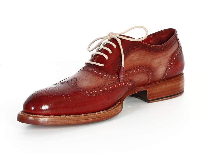Discover the sophistication of the Paul Parkman Wingtip Oxfords in Bordeaux & Camel, featuring detailed perforations on exquisitely hand-painted leather. These brogue shoes, adorned with light brown laces and crafted with a Goodyear welt for lasting durability, are elegantly displayed from top and side views.