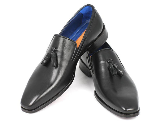 A pair of Paul Parkman Tassel Loafer Black - 5141-BLK, handcrafted for men from Italian calfskin leather, featuring a blue lining and elegantly placed one over the other.