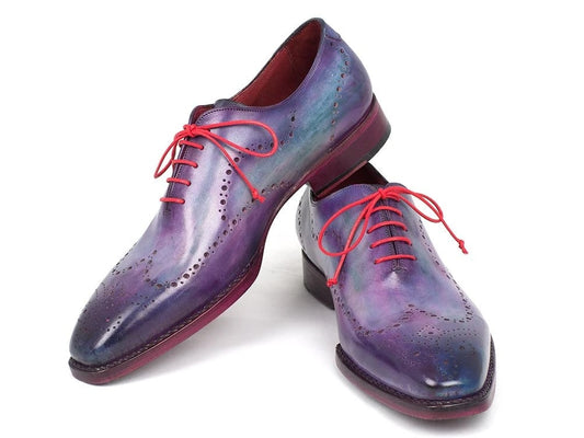 The Paul Parkman Wingtip Oxfords Goodyear Welted Purple - 87PRP11 are expertly crafted, featuring exquisite purple leather with red laces and decorative perforations. Handmade with a Goodyear welted construction, these dress shoes promise both style and durability, making them a standout addition to any wardrobe.