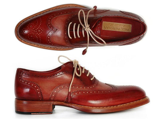 Discover the sophistication of the Paul Parkman Wingtip Oxfords in Bordeaux & Camel, featuring detailed perforations on exquisitely hand-painted leather. These brogue shoes, adorned with light brown laces and crafted with a Goodyear welt for lasting durability, are elegantly displayed from top and side views.
