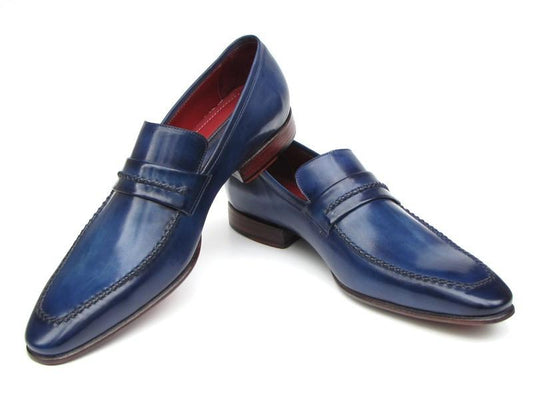 A pair of Paul Parkman Loafer Shoes Navy - 068-BLU, crafted from Italian calfskin with a red interior lining and brown soles, positioned one leaning on the other.