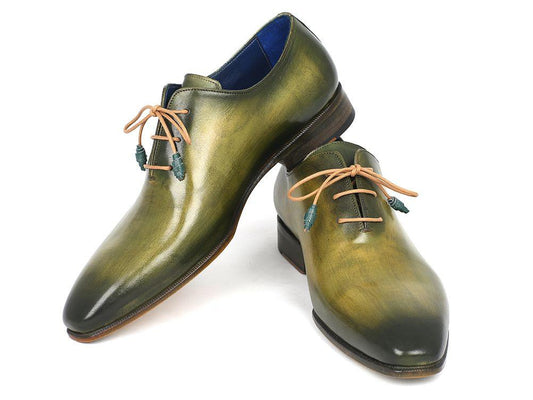 Displayed against a white backdrop, the Paul Parkman Plain Toe Wholecut Oxfords in green handpainted leather (model 755-GRN) feature elegant brown laces and wooden soles, highlighting their exquisite craftsmanship.