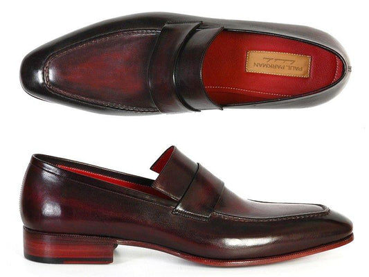 Introducing the Paul Parkman Loafer Purple & Black Hand-Painted Shoes - 093-PURP-BLK. These men's slip-on loafers, crafted by Paul Parkman, feature a blend of purple and black hues with intricate strap detailing. Designed with a low heel and luxurious red insoles, they offer a bespoke luxury experience with outstanding craftsmanship.