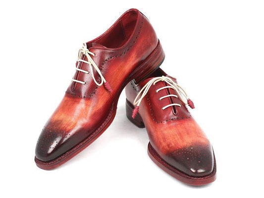 Introducing the Paul Parkman Reddish Camel Medallion Toe Oxfords - 0251, a stunning pair of elegant handmade shoes by Paul Parkman. These Oxfords feature a classic medallion toe design in rich red and brown hues, adorned with white laces and intricate brogue detailing. Crafted from hand-painted leather, they showcase sophistication through their timeless Goodyear welted construction.