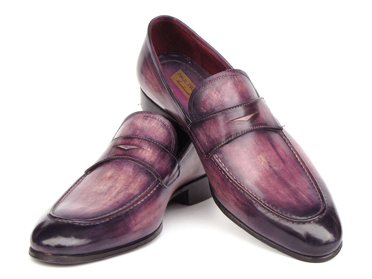 A pair of Paul Parkman Men's Purple Patina Penny Loafers - 17PRP33, crafted from hand-painted leather with a strap across the front, displayed on a white background.