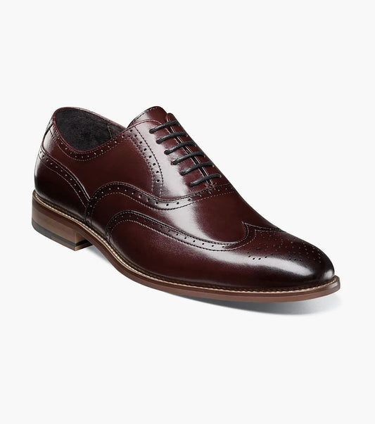 Stacy Adams Dunbar Wingtip Oxford from STACY ADAMS in burgundy (model 25064-601) featuring sophisticated perforated detailing and closed lacing, displayed sideways against a white background.