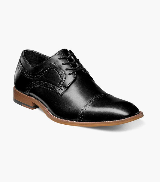 The Stacy Adams Dickinson Cap Toe Oxford (25066-001) features black leather, a brown sole, closed laces, decorative toe and side stitching, plus a cushioned insole for comfort. Shown on a plain white background.