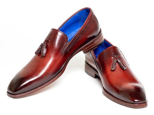 A pair of Paul Parkman Tassel Loafer Garnet Brown - 5141GBRW, featuring polished brown Italian calfskin leather with a sophisticated blue inner lining, stacked elegantly on each other.