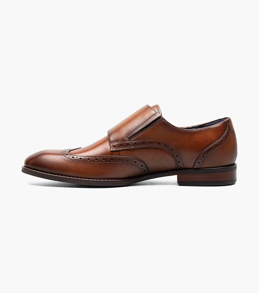 The STACY ADAMS Karson Wingtip Double Monk Strap dress shoe in Cognac features decorative perforations and a low heel, shown on a white background. Model: 25570-221.