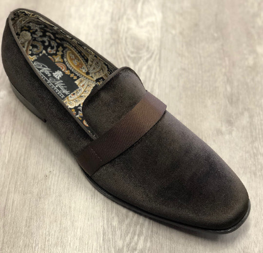 The After Midnight Formal Shoe 6660 Brown by AFTER MIDNIGHT features a brown suede design with a decorative strap and a patterned interior, elegantly placed on a wooden surface.