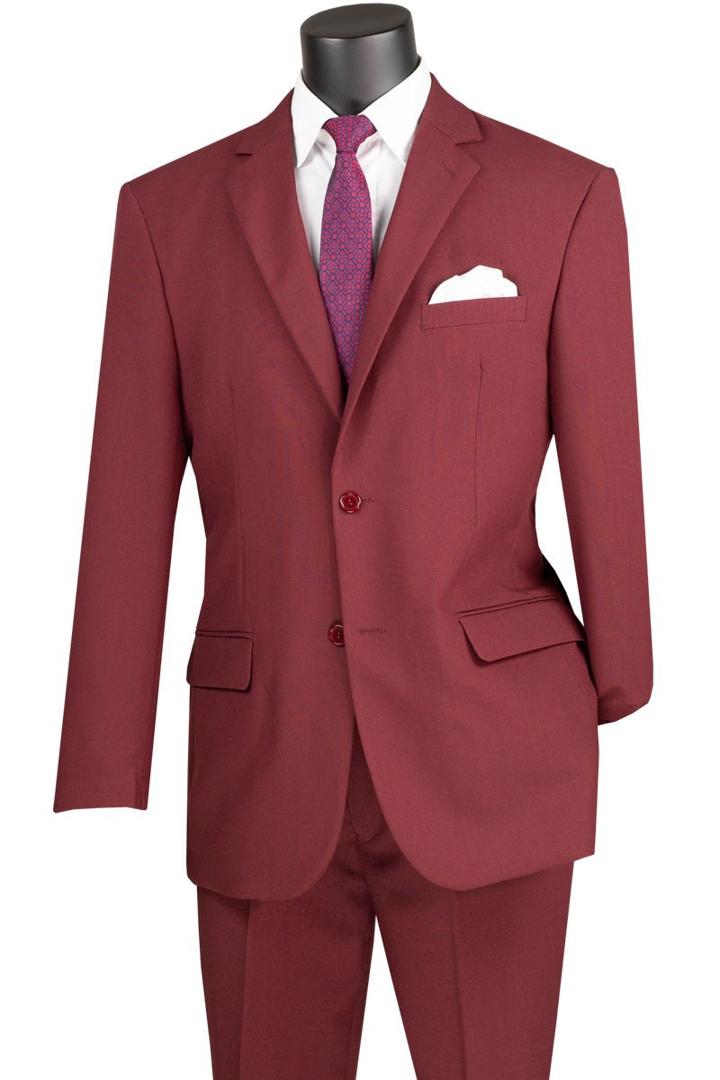 A burgundy Vinci Suits Single Breasted Poplin Dacron Suit on a mannequin shows off flat front pants and a single-breasted jacket with side vents, paired with a crisp white shirt, a purple tie, and a pristine white pocket square.